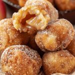 several desserts are stacked on top of each other in small bowls with apple slices and powdered sugar