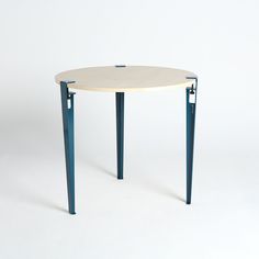 a white table with blue metal legs on a white background in the shape of a circle