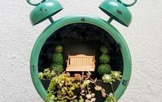 a small wooden bench sitting inside of a green planter