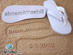 two pairs of white slippers with the name and number on them are laying in the sand