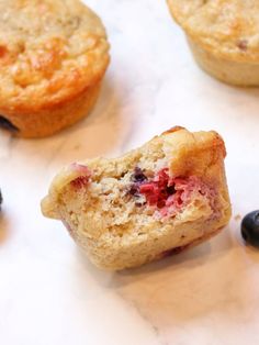 blueberries and muffins are sitting on the counter