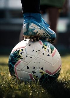 a person standing on top of a soccer ball