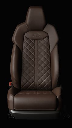 the front seat of a car with brown leather upholstered and stitching on it