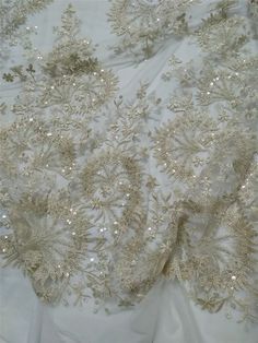 "This stunning Lace Fabric design piece has soft hand feel, It's perfect for weddings, bridal parties, and any events. Shop our large inventory of bridal fabrics. ☆PRODUCT DESCRIPTION : This gorgeous fabric is made on a sheer base with a beautiful vintage embroidery and delicate beaded throughout. The fabric width is approximately 51\" (130cm) Wide. Color: light champagne as in picture Material: Rayon, Polyester，Sequins, Pearls ☆ PURCHASING INFORMATION: This fabric is sold by the yard and each Q Elegant Gold Embroidered Fabric For Wedding, Elegant Wedding Fabric With Gold Embroidery, Embellished Lace Mother Of The Bride Dress For Banquet, Elegant Embroidered Sequin Fabric For Wedding, Gold Embellished Wedding Dress For Party, Embellished Gold Wedding Dress For Party, Gold Sparkling Sequin Fabric For Wedding, Sequin Lace Mother Of The Bride Dress For Wedding, Glamorous Fitted Embroidered Fabric For Wedding