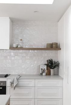 a kitchen with white cupboards and counters