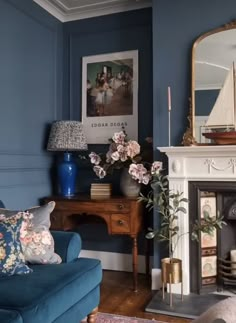 a living room filled with furniture and a fire place next to a painting on the wall