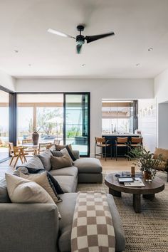 a living room filled with furniture and a ceiling fan