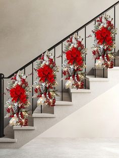 a set of stairs decorated with red flowers and pine cones for christmas decorations on each handrail