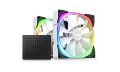 two colorful fans sitting next to each other on top of a white surface and one is black