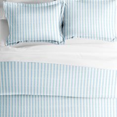 a bed with blue and white striped sheets