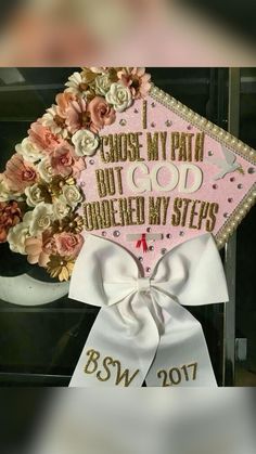 a pink and white graduation cap with flowers on the side that says, i choose my math but god answered my steps