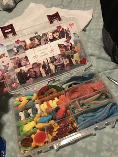 a plastic container filled with lots of candy and candies on top of a table