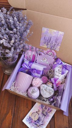 the lavender box is filled with soaps, candles, and other things to put in it