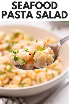 a spoon full of seafood pasta with parsley on top and the title above it