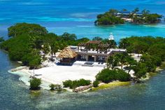 an island with a thatched roof surrounded by water