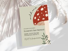 a red mushroom birthday party card on a white background with palm fronds in the foreground