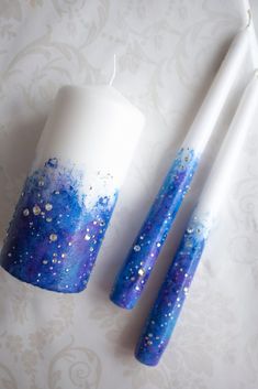 two candles with blue and white designs on them