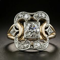 an antique diamond ring with two tone gold and white diamonds on it's sides