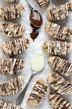 there are many cookies with chocolate drizzled on them and one has a spoon in it