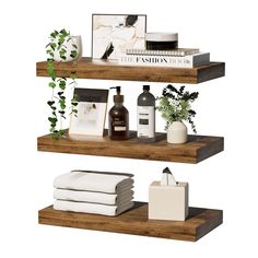 three wooden shelves with various items on them and one shelf holding toiletries, books, and plants