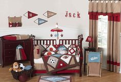 a baby's room is decorated in red, white and blue with sports themed crib bedding