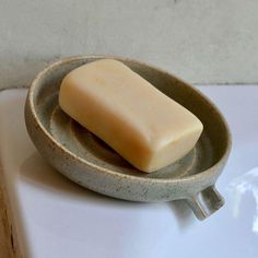 a bar of soap sitting in a bowl on a counter