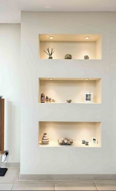 three white shelves with various items on them