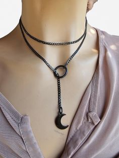 This is a bold and edgy blackened steel Gothic moon minimalist Lariat Necklace choker with a great Pagan witch aesthetic. This is a minimalistic, small curb chain with .5 inch crescent moon charm. The minimalist design gives it a trendy and stylish feel, while the black steel gives it a touch of gothic Punk edge. Please understand that this necklace is not designed for play, it is ornamental. This necklace is versatile and can be worn long or doubled up for a layered look, depending on what size Black Metal Jewelry With Moon Charm, Edgy Gunmetal Jewelry With Adjustable Fit, Adjustable Gunmetal Edgy Jewelry, Black Crescent Metal Jewelry, Black Metal Crescent Jewelry, Black Metal Moon Shaped Jewelry, Black Metal Moon-shaped Jewelry, Black Crescent Metal Necklace, Black Metal Crescent Necklace