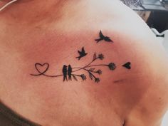 a woman's chest with birds on it and flowers in the shape of hearts