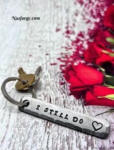 a keychain that says i still do on it with flowers in the background