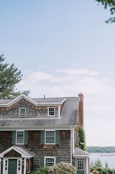 a large house sitting next to a body of water