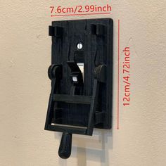 a wall mounted light switch on the side of a white wall with measurements for it