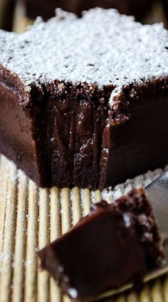 a piece of chocolate cake sitting on top of a wooden table