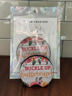 two stickers with the words buckle up butterfly cup on them