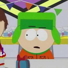 the south park characters are sitting at a table with a cake in front of them