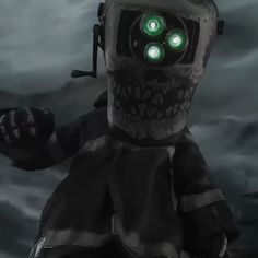 a robot with green eyes standing in front of a dark background and holding his hand up to the camera