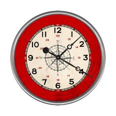 a red and white wall clock with numbers on the face, in front of a white background