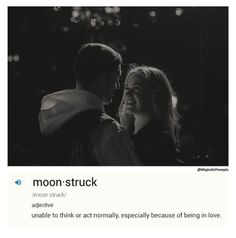 a black and white photo of two people smiling at each other with the caption moon struck above them