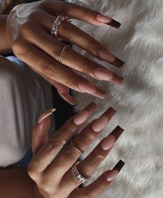 the woman is holding her hands together with two different rings on their thumbnails