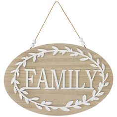 a wooden sign with the word family hanging from it's side and an oval frame