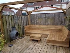 a wooden bench sitting on top of a wooden deck