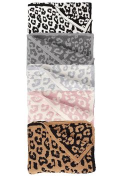 four leopard print scarves stacked on top of each other in different colors and patterns