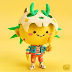 a yellow toy with green leaves on it's head and ears, standing in front of a yellow background