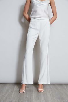 We chose our favorite Fluid Crepe for the season's must have pant. Incredibly flattering with a fit & flare leg - these pants are detailed with a partially lined lace insert down the sides for a glimpse of leg. Get ready for the compliments. Elie Tahari Exclusive Fit & Flare Fluid Crepe Pant with Lace Side Stripes 70% Triacetate, 30% Polyester Runs true to size. Model is 5'9" and wearing size 2 Measurements: 10"L front rise 33.5"L inseam (approx. length for a size 6) Dry Clean Only Imported Styl Evening Pants With Lace Trim, Elegant Fitted Bottoms With Lace Trim, Elegant Evening Bottoms With Lace Trim, Elegant Lace Trim Evening Bottoms, Fitted Formal Bottoms With Lace Trim, Elegant Lace Trim Bottoms For Spring, Chic Stretch Bottoms With Lace Trim, Elegant Stretch Pants With Lace Trim, Elegant Long Pants With Lace Trim