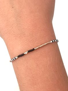 This tiny beaded bracelet is all about effortless style and boho vibes.  Featuring a mix of black,  gold, and tan beads, this bracelet brings a splash of sparkle to any outfit.  Its adjustable design makes it a perfect fit for everyone, whether you're layering it up or keeping it simple for a laid-back day out.  Add this boho beauty to your collection and let your style shine! Will fit wrists from 5 3/4" - 7". Comes neatly packaged for you or ready to gift. Recommended care:  To prolong your new piece, remove before pools, ocean, and shower. Black And Gold Bracelet, Boho Beauty, Bracelet Simple, Seed Bead Bracelet, Simple Bracelets, Boho Bracelet, Bracelet Boho, Seed Bead Bracelets, Boho Vibe