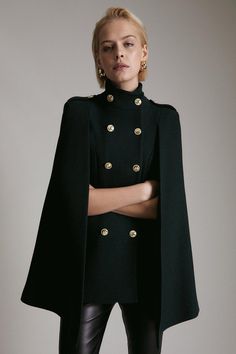 A chic combination of fine Italian wool and modern military-style tailoring make this cape a style to covet. Neat rows of glossy buttons, smart epaulettes and roomy pockets ensure a polished take on keeping out the cold – style this investment piece with leather leggings for a smart finish. Cape Women, Military Style Fashion, Elegant Cape, Chic Fashion Aesthetic, Military Outfits, Military Core Outfits, Military Style, Military Clothes, Modern Chic Outfits