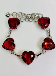 Silver Heart Bracelet For Valentine's Day Party, Elegant Handmade Metal Heart Bracelet, Red Jeweled Bracelets As Gift, Red Jeweled Bracelets For Gift, Elegant Red Heart Bracelet Gift, Elegant Red Heart Bracelet For Gift, Valentine's Day Sterling Silver Heart Cut Bracelet, Silver Heart-shaped Jeweled Jewelry, Silver Heart-shaped Jewelry With Jewels