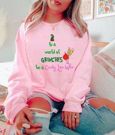 "In A World Full Of Griches Be A Cindy Lou Who Shirt, Christmas Shirt, Holiday Shirt, Grich Shirt, Cindy Lou Who, Christmas T-Shirt, Grich. Available in white/ash/sand/light blue/light pink. Please refer to size chart for measurements. ♡ HOW TO ORDER 1️⃣ Swipe to all of the pictures. 2️⃣ Select style and size from drop down menus. 3️⃣ Select shirt colors from drop down menus. 4️⃣ Select quantity and click \"add to cart\". 5️⃣ For every single shirt you have to repeat every step.. ♡ MATERIAL INFO * This updated unisex features design with superior combed ring-spun cotton. * Ultra Soft * Sideseamed * Retail fit * Unisex sizing * Shoulder taping ♡ PROCESSING TIMES INFO * We ships the order the next day. * Rush options are available at check out. ♡ SHIPPING INFO Standard: 3-5 days to deliver y Cindy Lou Who Shirt, Grinch Sweatshirt, Grinch Movie, The Grinch Movie, Movie Christmas, Cindy Lou Who, Single Shirt, Christmas Grinch, Cindy Lou