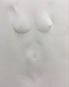 a white piece of paper that has some watercolor paint on it, with two small circles in the middle