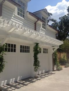 a white house with some plants growing on it